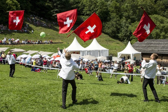 epa06119833 A group of flag-swingers with Swiss flags at the Ruetli meadow above the Lake Lucerne, Switzerland, 01 August 2017. Switzerland celebrates the National Day on 01 August. EPA/ALEXANDRA WEY