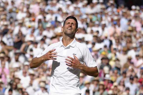 Serbia&#039;s Novak Djokovic celebrates after beating Australia&#039;s Nick Kyrgios to win the final of the men&#039;s singles on day fourteen of the Wimbledon tennis championships in London, Sunday,  ...