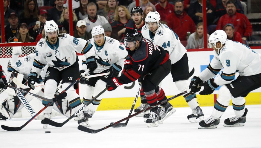 San Jose Sharks&#039; Erik Karlsson (65) of Sweden, Joe Pavelski (8), Marc-Edouard Vlasic (44) and Evander Kane (9) defend the Carolina Hurricanes&#039; Lucas Wallmark (71) of Sweden during the first  ...