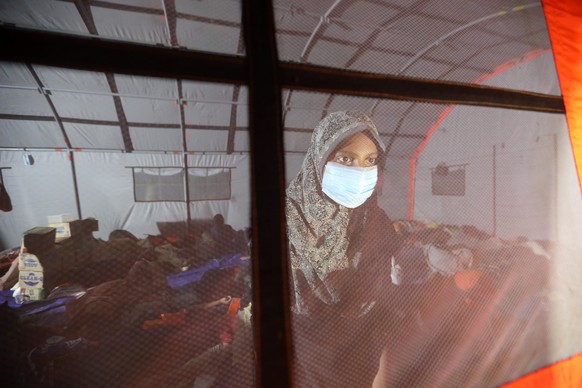 epa09248769 Rohingya refugees rest inside a tent provided by the Indonesian Disaster Agency, on Idaman island, East Aceh, Indonesia, 05 June 2021. About 81 Rohingya refugees were stranded on Idaman Is ...