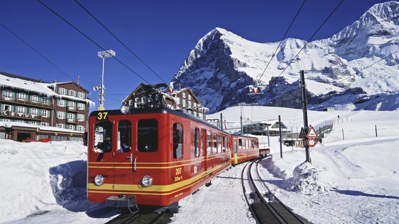 ZU DEN JAHRESZAHLEN DER JUNGFRAUBAHN, STELLEN WIR IHNEN HEUTE, 4. APRIL 2018, FOLGENDES BILDMATERIAL ZUR VERFUEGUNG - A train of the Jungfraubahn railway departs from the station on the Kleine Scheide ...