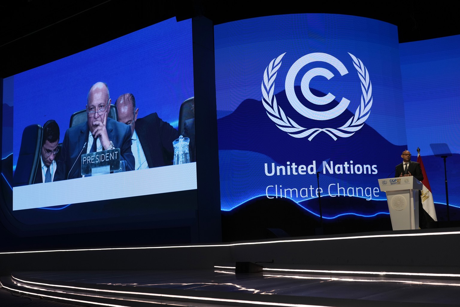 Sameh Shoukry, president of the COP27 climate summit, left, listens as Simon Stiell, U.N. climate chief, speaks during a closing plenary session at the COP27 U.N. Climate Summit, Sunday, Nov. 20, 2022 ...