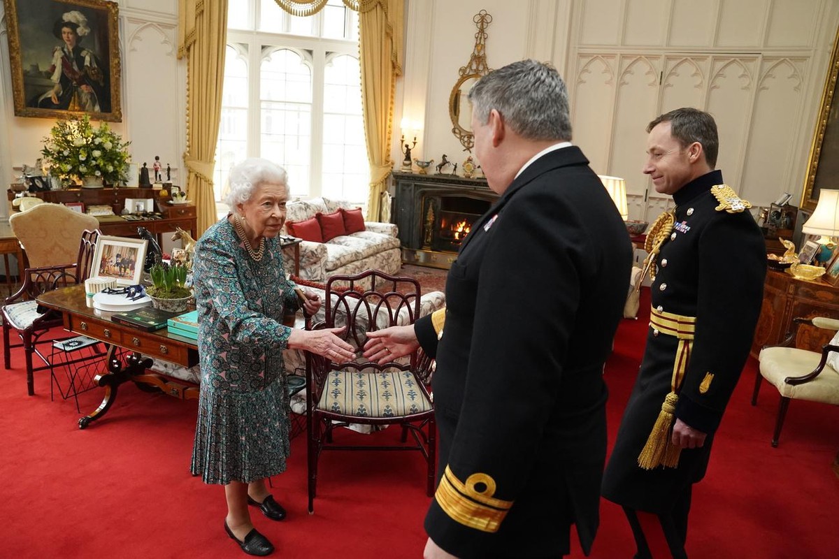 Britain's Queen Elizabeth II speaks with Rear Admiral James Macleod and Major General Eldon Millar, right, as she meets the incoming and outgoing Defence Service Secretaries, Wednesday Feb. 16, 2 ...