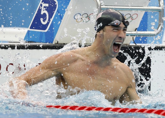 FILE - In this Aug. 16, 2008 file photo, United States' Michael Phelps reacts as he wins gold in the final of the men's 100-meter freestyle during the swimming competitions in the National Aquatics Ce ...