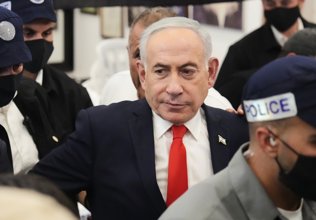 Israeli Prime Minister Benjamin Netanyahu, leader of the Likud party, is surrounded by security personnel during a campaign appearance at a market in Tel Aviv, Israel, Thursday, Oct. 22, 2026, ahead o ...