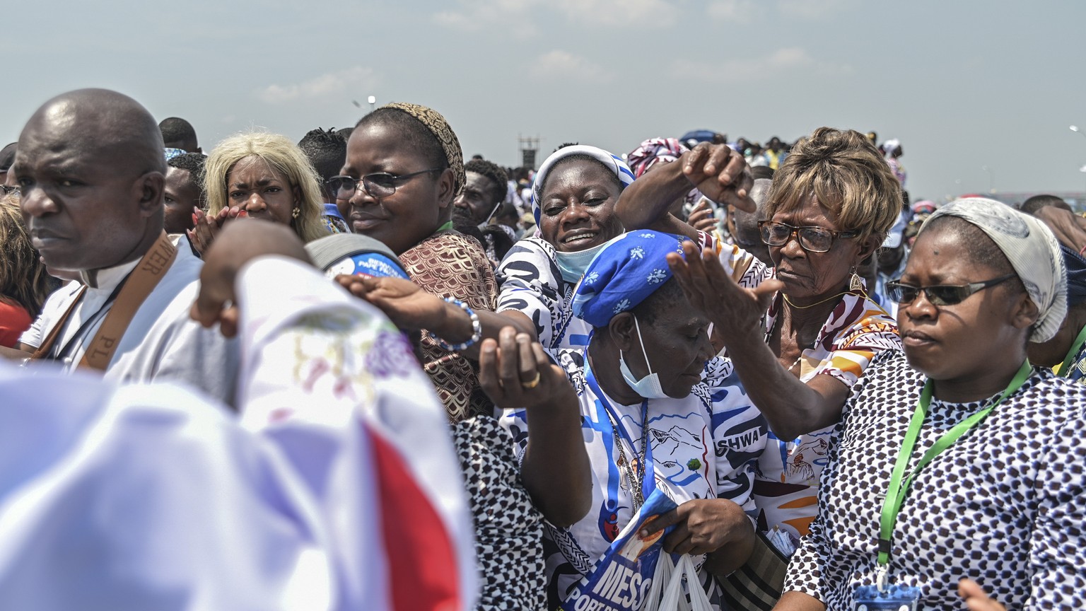 Women receive communion after Pope Francis celebrated Holy Mass at Ndolo airport in Kinshasa, Congo, Wednesday Feb. 1, 2023. Francis is in Congo and South Sudan for a six-day trip, hoping to bring com ...