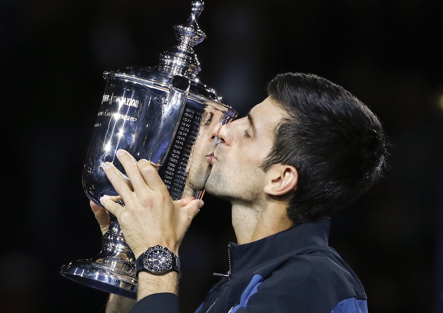 FILE - In this Sept. 9, 2018, file photo, Novak Djokovic, of Serbia, kisses the trophy after defeating Juan Martin del Potro, of Argentina, in the men&#039;s final of the U.S. Open tennis tournament,  ...