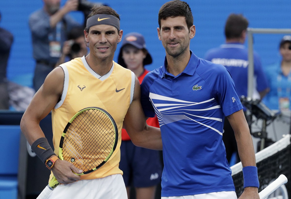 Spain's Rafael Nadal, left, poses for a photo with Serbia's Novak Djokovic ahead of the men's singles final at the Australian Open tennis championships in Melbourne, Australia, Sunday,  ...