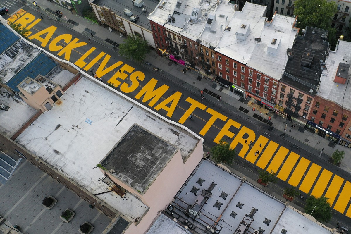 FILE - In this June 15, 2020, file photo, a sign reading "Black Lives Matter," is painted in orange on Fulton Street in the Brooklyn borough of New York. On Thursday, June 25, 2020, Presiden ...