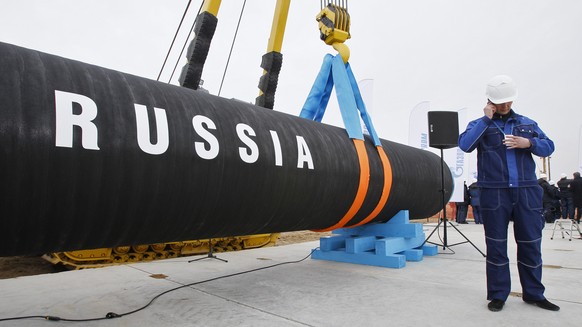 FILE - A Russian construction worker speaks on a mobile phone during a ceremony marking the start of Nord Stream pipeline construction in Portovaya Bay some 170 kms (106 miles) north-west from St. Pet ...