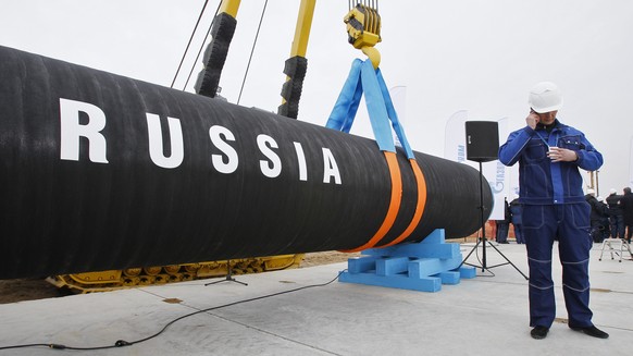 FILE - A Russian construction worker speaks on a mobile phone during a ceremony marking the start of Nord Stream pipeline construction in Portovaya Bay some 170 kms (106 miles) north-west from St. Pet ...