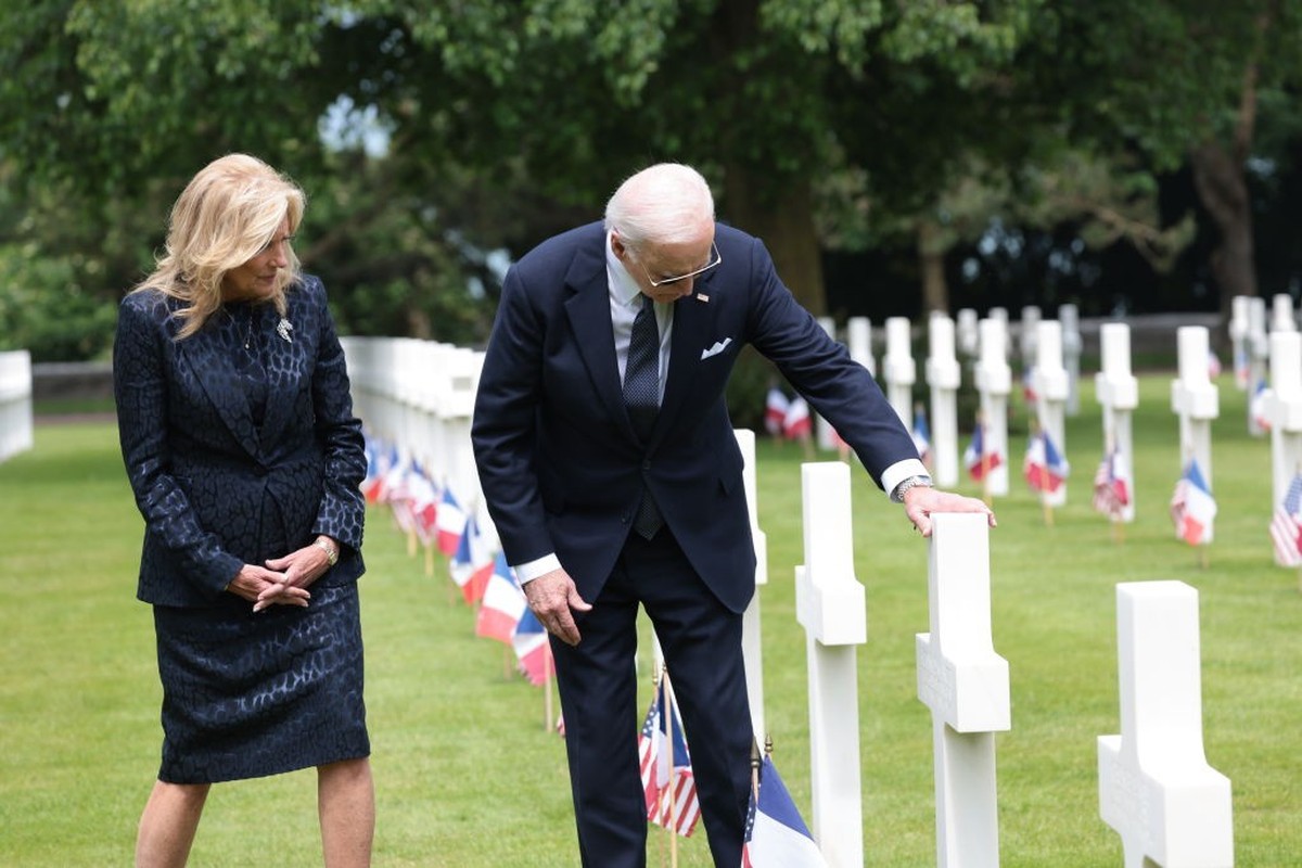 COLLEVILLE-SUR-MER, FRANCE - JUNE 06: U.S. President Joe Biden reaches out to touch a U.S. soldier's tombstone as he and first lady Jill Biden tour the Normandy American Cemetery on the 80th anni ...