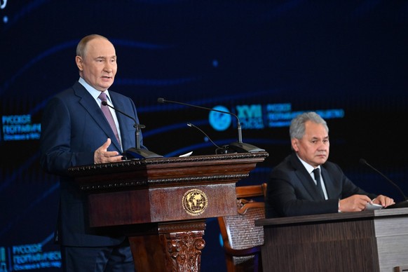 Moscow. Russian President Vladimir Putin at the 17th Congress of the Russian Geographical Society RGS in the State Kremlin Palace. On the right is Secretary of the Russian Security Council and Preside ...