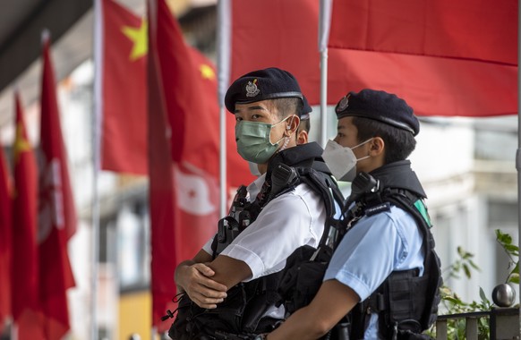 epa10216779 Police officers stand guard during China's National Day in Hong Kong, China, October 1, 2022. China will celebrate its National Day on October 1, 2022, marking the 73rd anniversary of ...