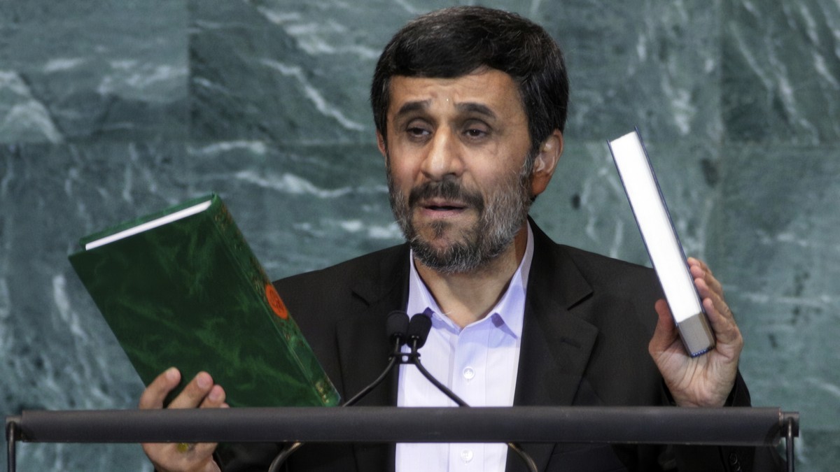 FILE - Iran's President Mahmoud Ahmadinejad, President of Iran, holds up a copies of the Quran, left, and Bible, right, as he addresses the 65th session of the United Nations General Assembly at  ...
