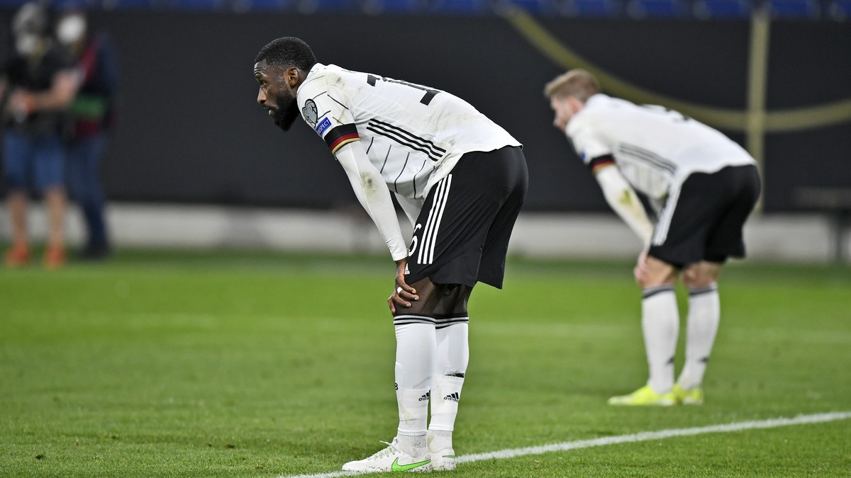 Germany's Antonio Ruediger stands on the pitch disappointed after losing the World Cup 2022 group J qualifying soccer match between Germany and North Macedonia in Duisburg, Germany, Wednesday, Ma ...