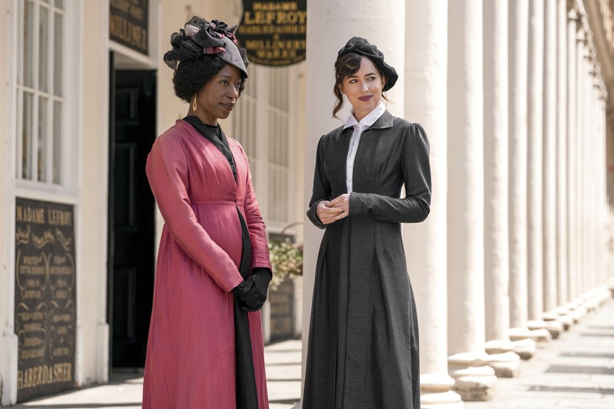 This image released by Netflix shows Nikki Amuka-Bird, left, and Dakota Johnson in a scene from &quot;Persuasion.&quot; (Nick Wall/Netflix via AP)