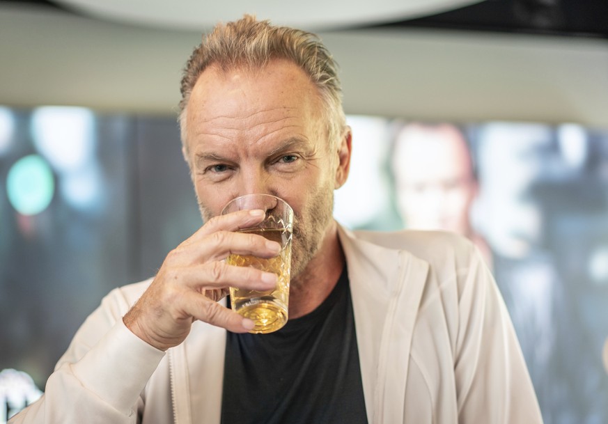 British rockstar Sting drinks a glass of German cider before an interview to promote his new album in a studio of a radio station in Bad Vilbel, Germany, Friday, May 3, 2019. (Frank Rumpenhorst/dpa vi ...