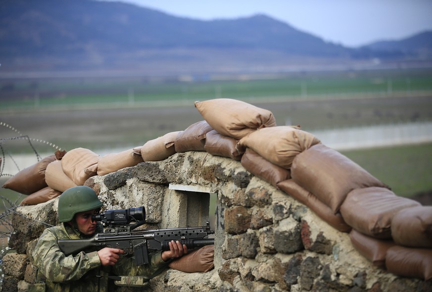 A Turkish army soldier holds his fighting position during exercises, at a military outpost near the town of Kilis, southeastern Turkey, Thursday, March 2, 2017. Turkey&#039;s military is holding exerc ...