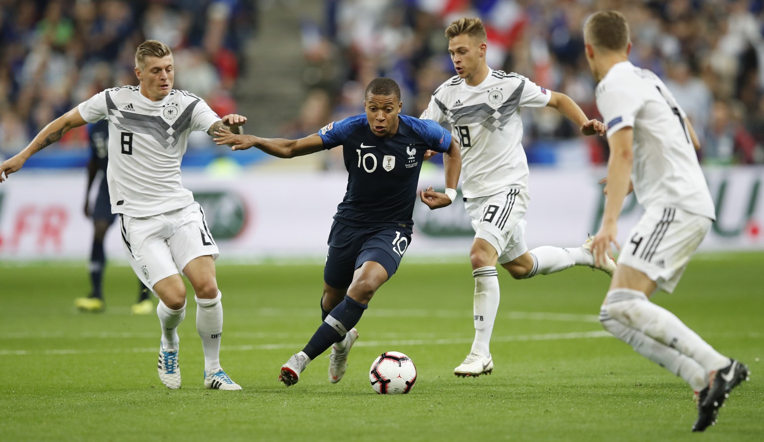 France&#039;s Kylian Mbappe, 2nd left, challenges for the ball with Germany&#039;s Toni Kroos, left, and Germany&#039;s Toni Kroos while Germany&#039;s Matthias Ginter, right, looks on during a UEFA N ...