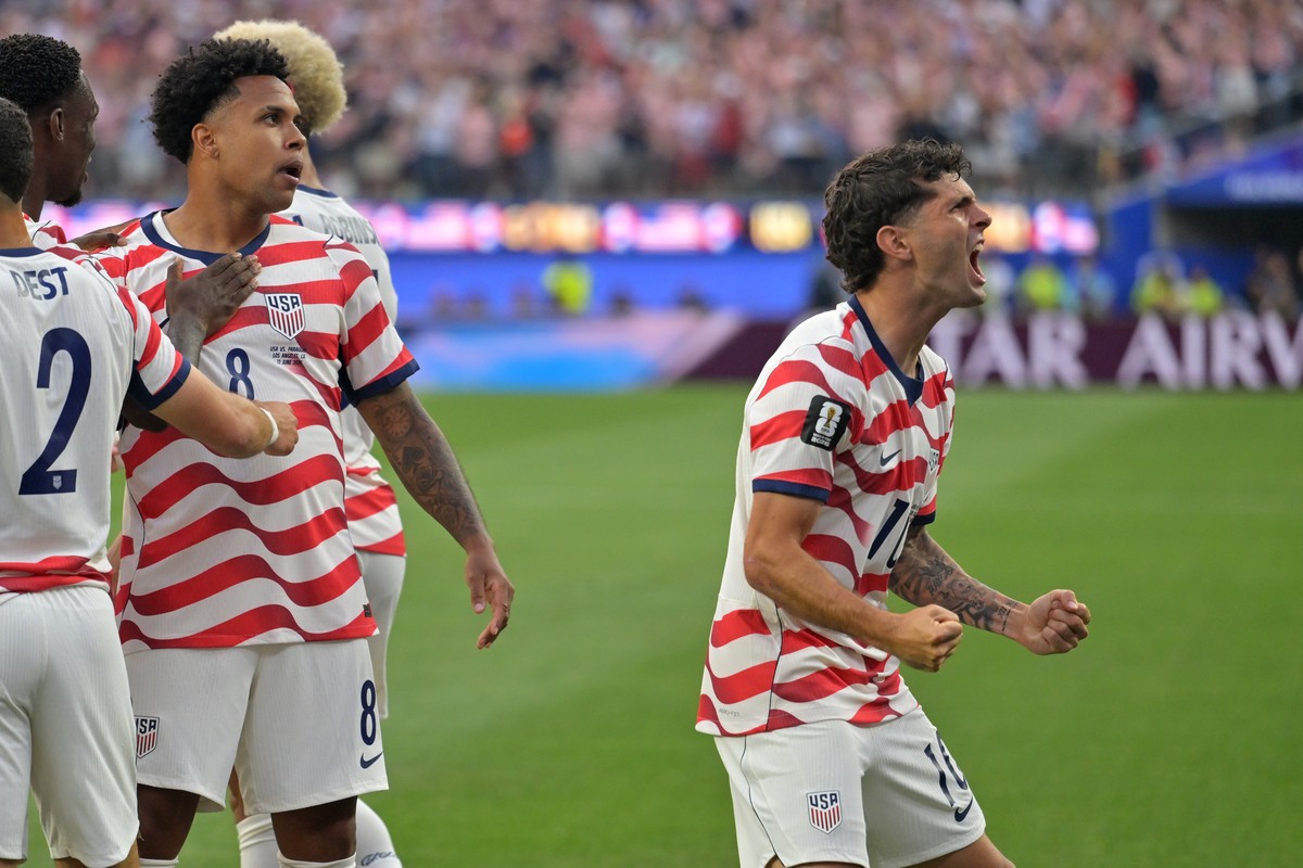 United States' Christian Pulisic, right, celebrates with teammates after an own goal by Paraguay's Damian Bobadilla during the World Cup Group D soccer match in Inglewood, Calif., near Los A ...