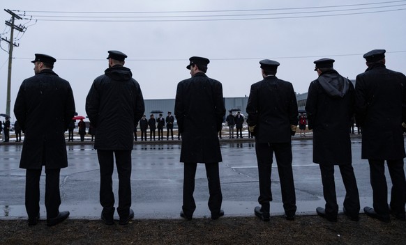 Pilots line the road outside Air Canada headquarters as they wait for the repatriation of Air Canada Jazz pilot Antoine Forest, in Montreal, Thursday, March 26, 2026. (Christinne Muschi/The Canadian P ...
