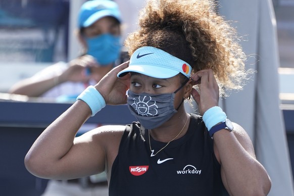 Naomi Osaka, of Japan, adjusts her face mask before an interview during the Miami Open tennis tournament, Monday, March 29, 2021, in Miami Gardens, Fla. (AP Photo/Marta Lavandier)
Naomi Osaka