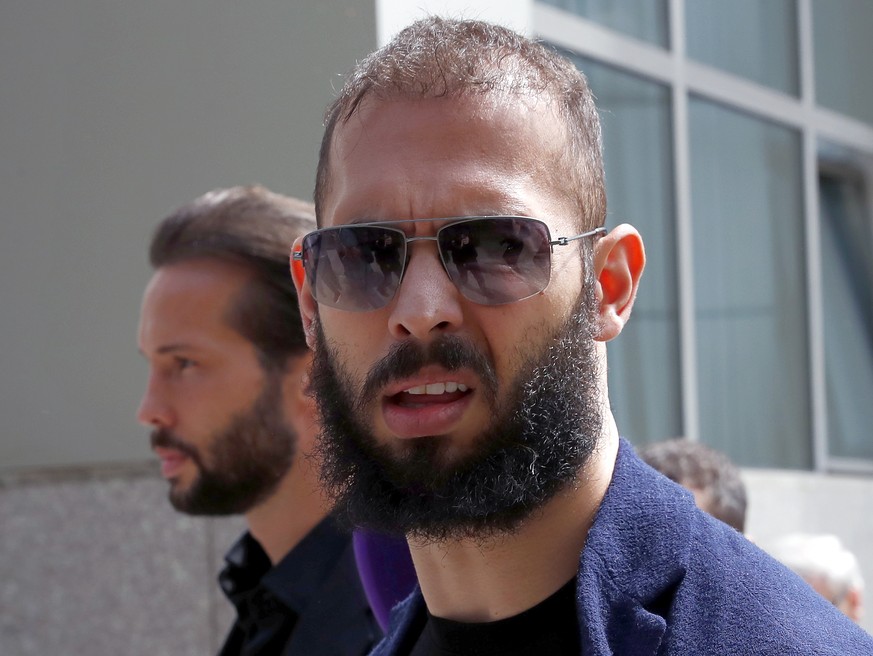 epa10638375 Former professional kickboxer and social media influencer Andrew Tate (R) and his brother Tristan (L) leave the court after being presented to a judge for an extension of their house arres ...