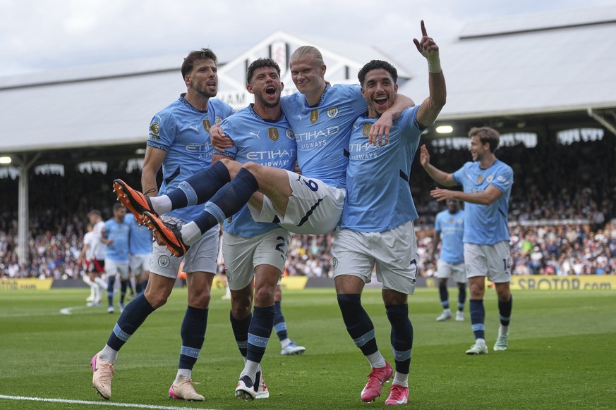 FILE - Manchester City players celebrate after Manchester City's Erling Haaland, center, scored his side's second goal during the English Premier League soccer match between Fulham and Manch ...