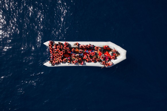 FILE - In this Sunday, May 6, 2018 file photo, refugees and migrants wait to be rescued by members of the Spanish NGO Proactiva Open Arms, after leaving Libya trying to reach European soil aboard an o ...