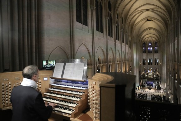 epa11763353 A musician plays the organ inside the Notre Dame de Paris cathedral, during a ceremony marking its official reopening, in Paris, France, 07 December 2024. The Notre Dame de Paris Cathedral ...