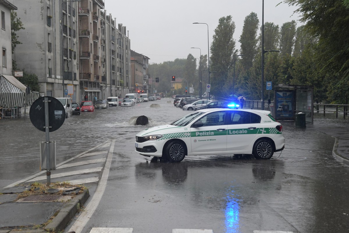 epa11587162 A police vehicle parked near a flooded road following bad weather that caused the overflow of the Lambro River in Milan, Italy, 05 September 2024. Floods occurred in Milan's Ponte Lam ...