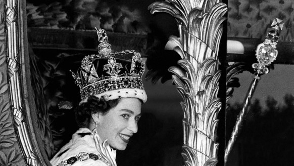 The Queen rides in the golden State Coach into Buckingham Palace at the end of her tirumphal progress from her Coronation at Westminster Abbey , today. She wears the Imperial State Crown , carries the ...