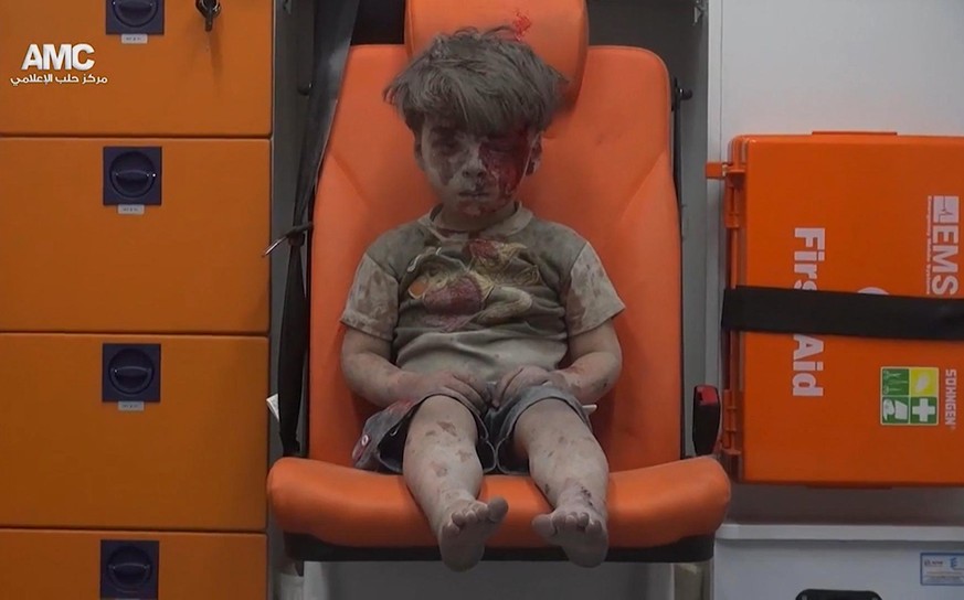 FILE- In this file frame grab taken from video on Wednesday, Aug. 17, 2016, which provided by the Syrian anti-government activist group Aleppo Media Center (AMC), 5-year-old Omran Daqneesh sits in an  ...