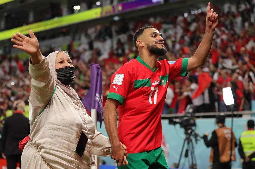 epa10359678 Sofiane Boufal of Morocco reacts with his mother after the FIFA World Cup 2022 quarter final soccer match between Morocco and Portugal at Al Thumama Stadium in Doha, Qatar, 10 December 202 ...
