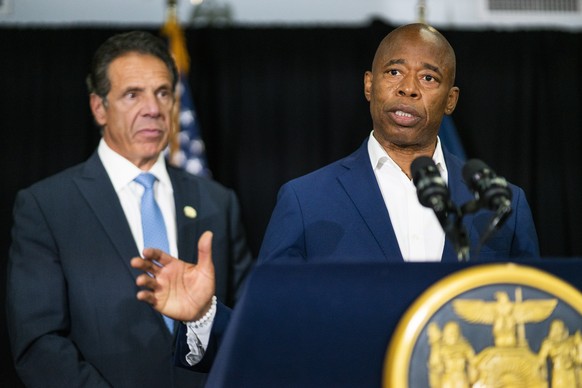 Brooklyn Borough President and New York City mayoral candidate Eric Adams, right, speaks to the media accompanied by Gov. Andrew Cuomo during a news conference at Lenox Road Baptist Church in the Broo ...