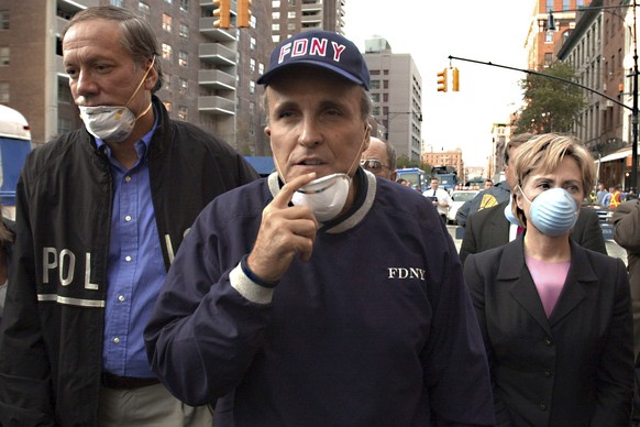 FILE?  New York Mayor Rudolph Giuliani, center, leads the New York Governor.  George Pataki, left, and Sen. Hillary Rodham Clinton, DY, during a tour of the World Trade Center disaster site, September 12 and 20...