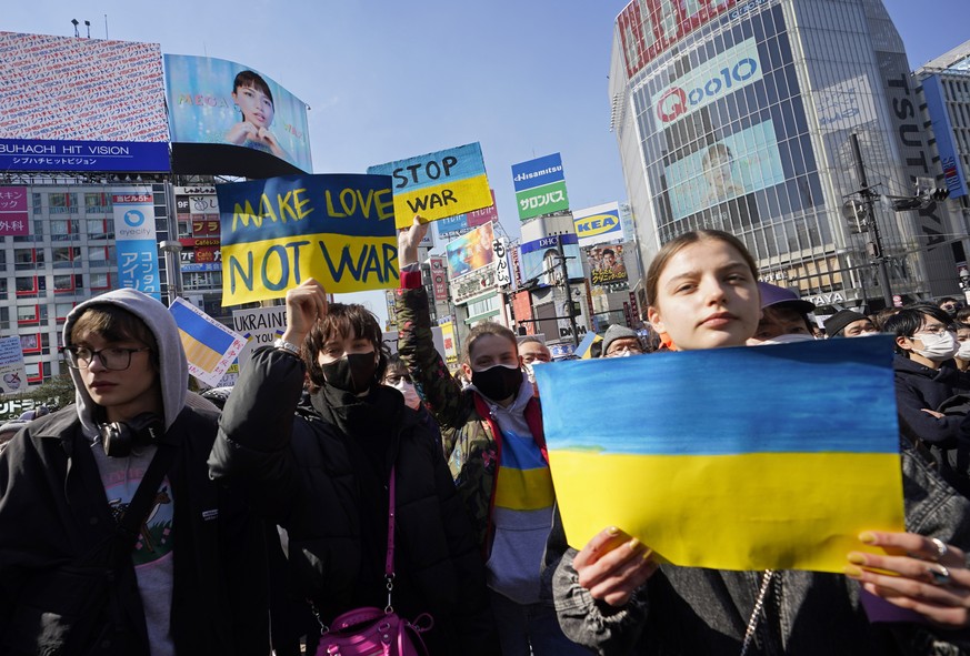epa09786238 People hold placards during a protest against Russia's invasion of Ukraine, in Tokyo, Japan, 26 February 2022. Russian troops entered Ukraine on 24 February prompting the country' ...