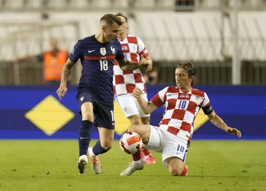 France&#039;s Lucas Digne, left, duels for the ball with Croatia&#039;s Luka Modric during the UEFA Nations League soccer match between Croatia and France at the Poljud stadium, in Split, Croatia, Mon ...