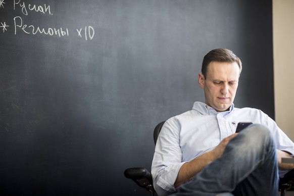 epa06611860 Russian liberal opposition leader and a head of an anti-corruption foundation Alexei Navalny works in his office during president elections, in Moscow, Russia, 18 March 2018. Alexei Navaln ...