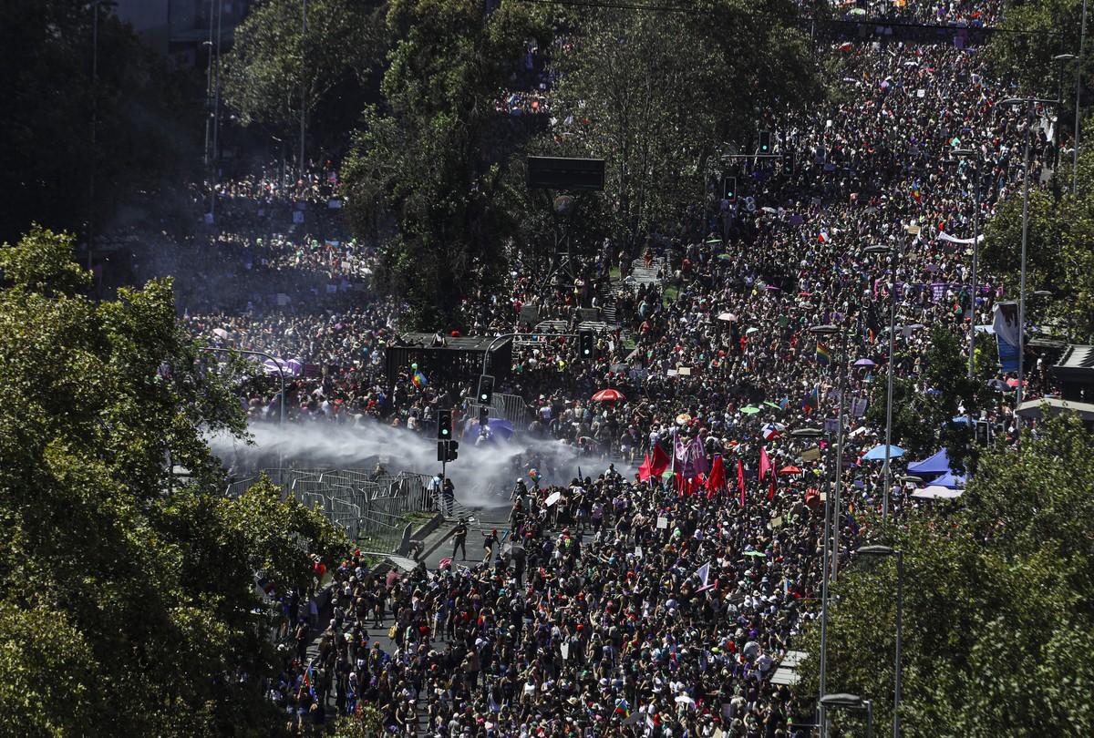 Women march and clash with police near La Moneda presidential palace during a protest marking the upcoming International Women's Day, in Santiago, Chile, Sunday, March 8, 2020. (AP Photo/Esteban  ...