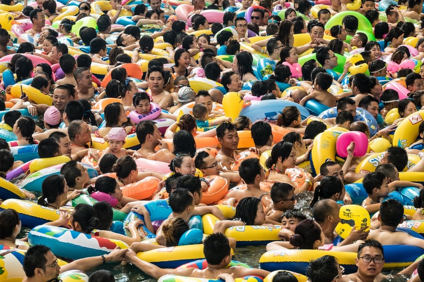 epa06105232 Chinese tourists with swim rings enjoy swimming in the lake called 'Dead sea of China' in a resort of Suining city, southwestern China's Sichuan province, 22 July 2017. More ...