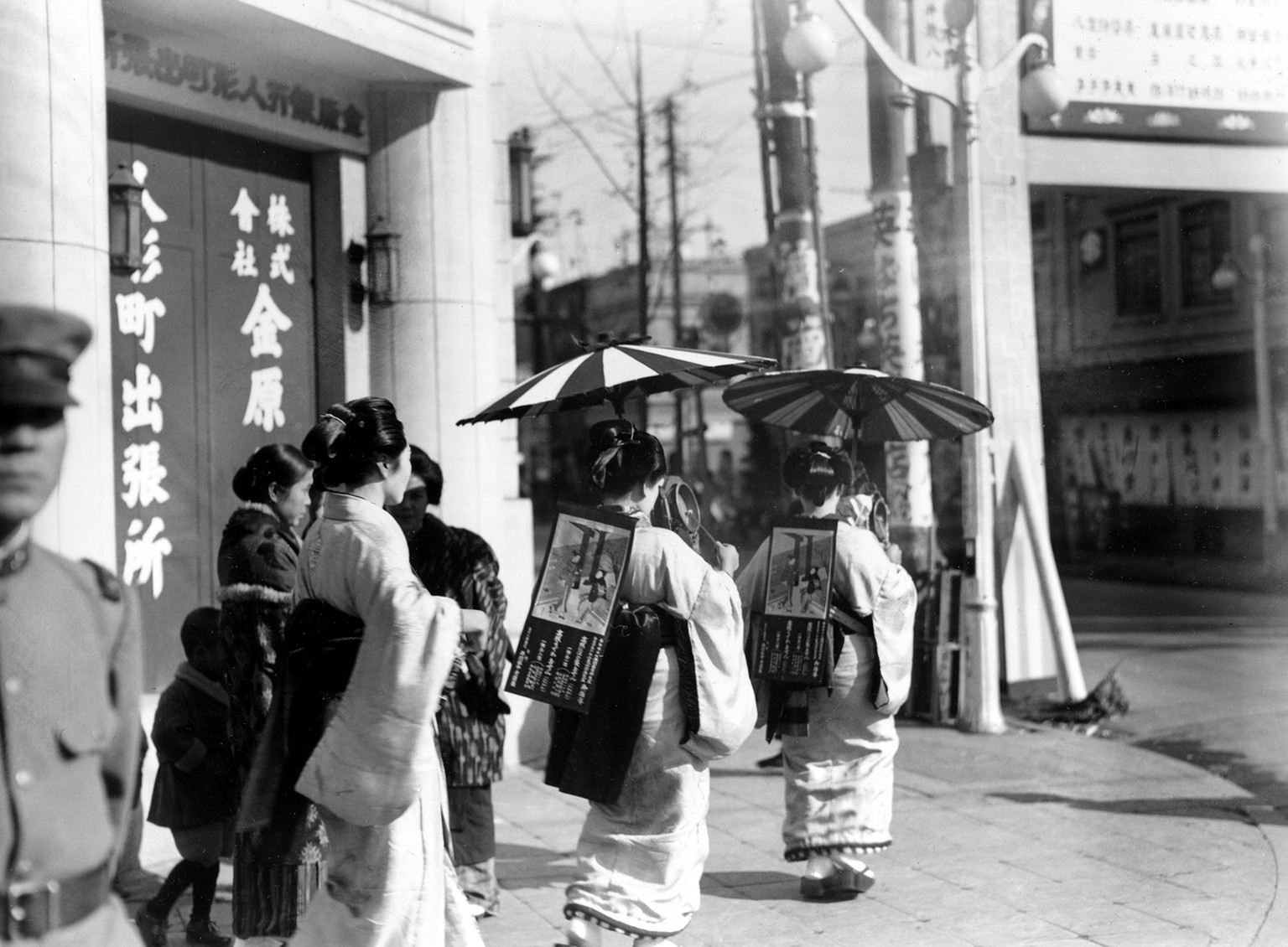 Japanese women wearing traditional costume parade as walking advertisments and beat drums to call attention to their ads through the streets of Tokyo, Japan, March 8, 1937. (AP Photo)