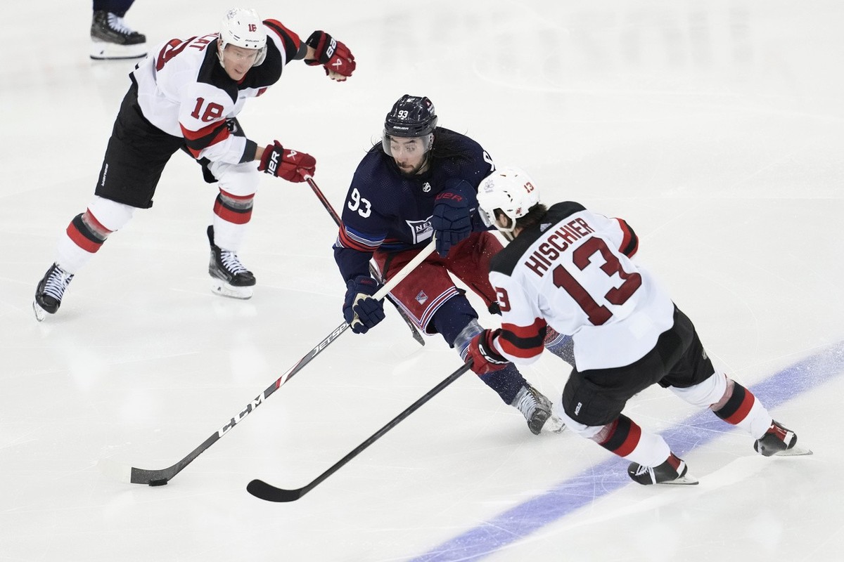 New York Rangers center Mika Zibanejad (93) skates against New Jersey Devils center Nico Hischier (13) and left wing Ondrej Palat (18) during the third period of an NHL hockey game Wednesday, April 3, ...