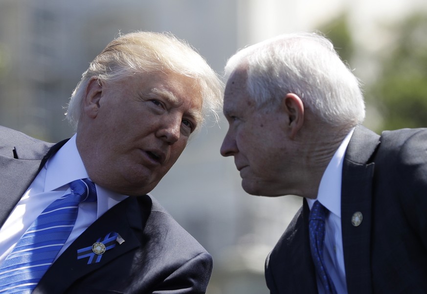 President Donald Trump talks with Attorney General Jeff Sessions, gestures before speaking at the 36th Annual National Peace Officers&#039; memorial service, Monday, May 15. 2017, on Capitol Hill in W ...