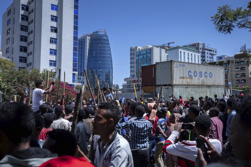 A group of supporters shout slogans at the house of opposition leader Jawar Mohammed to show their support, in Addis Ababa, Ethiopia, Thursday Oct. 24, 2019. EthiopiaÄôs Nobel Peace Prize-winning pri ...