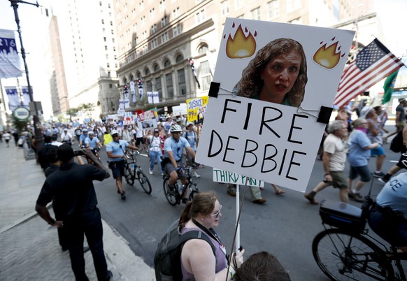 A supporters of Sen. Bernie Sanders, I-Vt., holds up a sign call calling for Debbie Wasserman Schultz, chairwoman of the Democratic National Committee to be fired, Sunday, July 24, 2016, in Philadelph ...