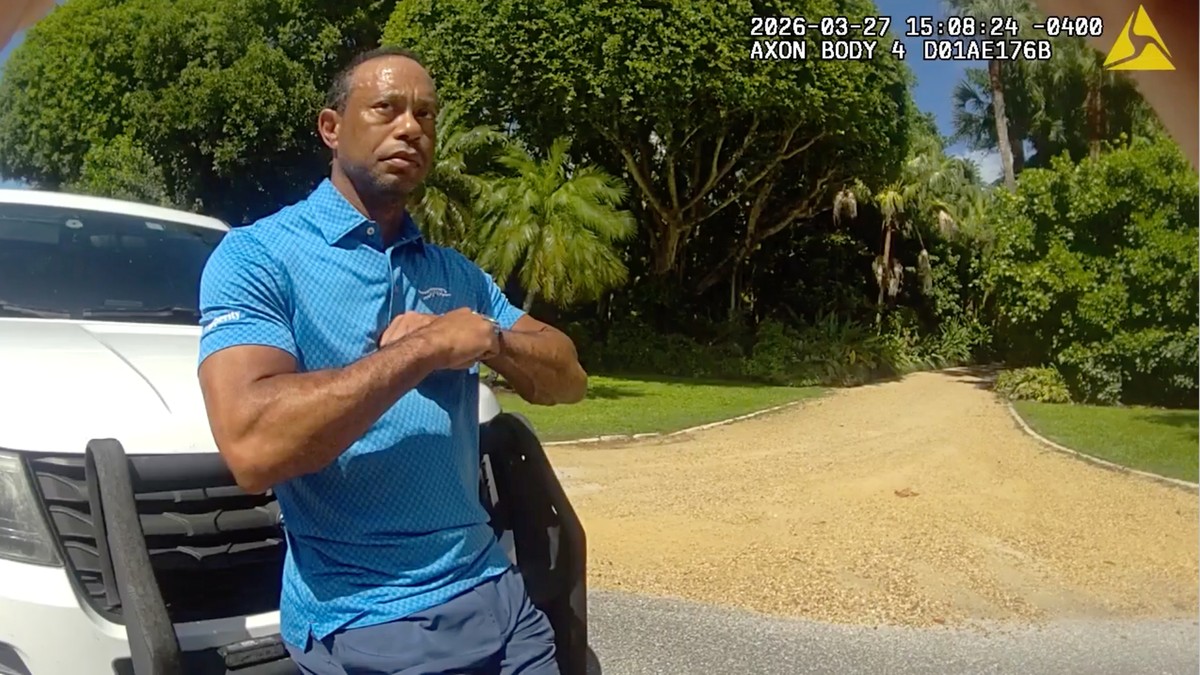 In this image from police body camera video released by the Martin County, Fla., Sheriff's Office, golfer Tiger Woods performs a field sobriety test for sheriff's deputies following a car cr ...