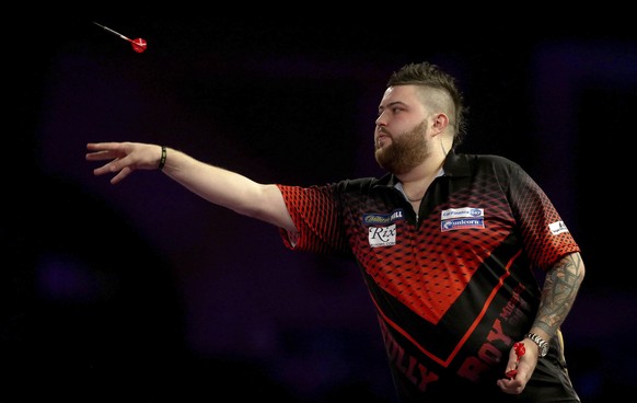 Britain's Michael Smith in action during day ten of the World Darts Championship at Alexandra Palace, in London, Saturday, Dec. 23, 2017.  (Steven Paston/PA via AP)