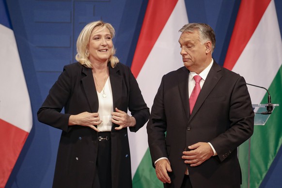 FILE -French far-right leader Marine le Pen adjusts her jacket at the end of a joint press conference with Hungarian Prime Minister Viktor Orban in Budapest, Hungary, Tuesday, Oct. 26, 2021. (AP Photo ...